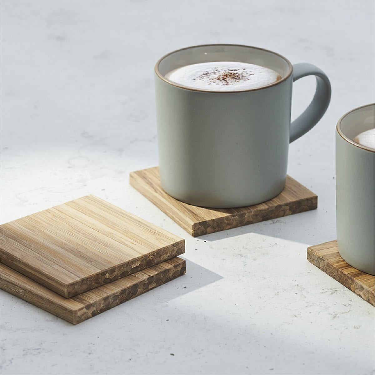 coasters and mugs of hot chocolate